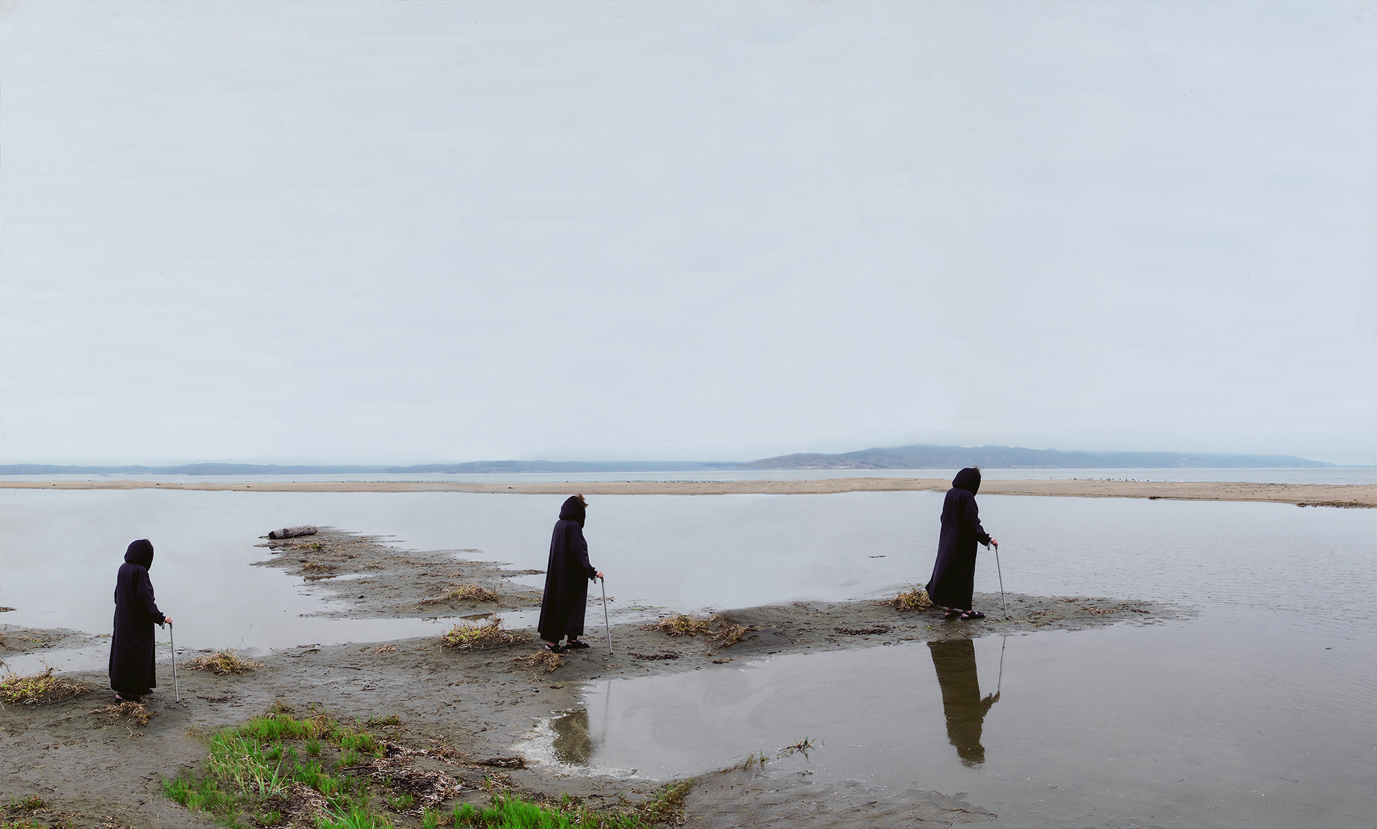 Time-lapse photograph of a woman walking near water