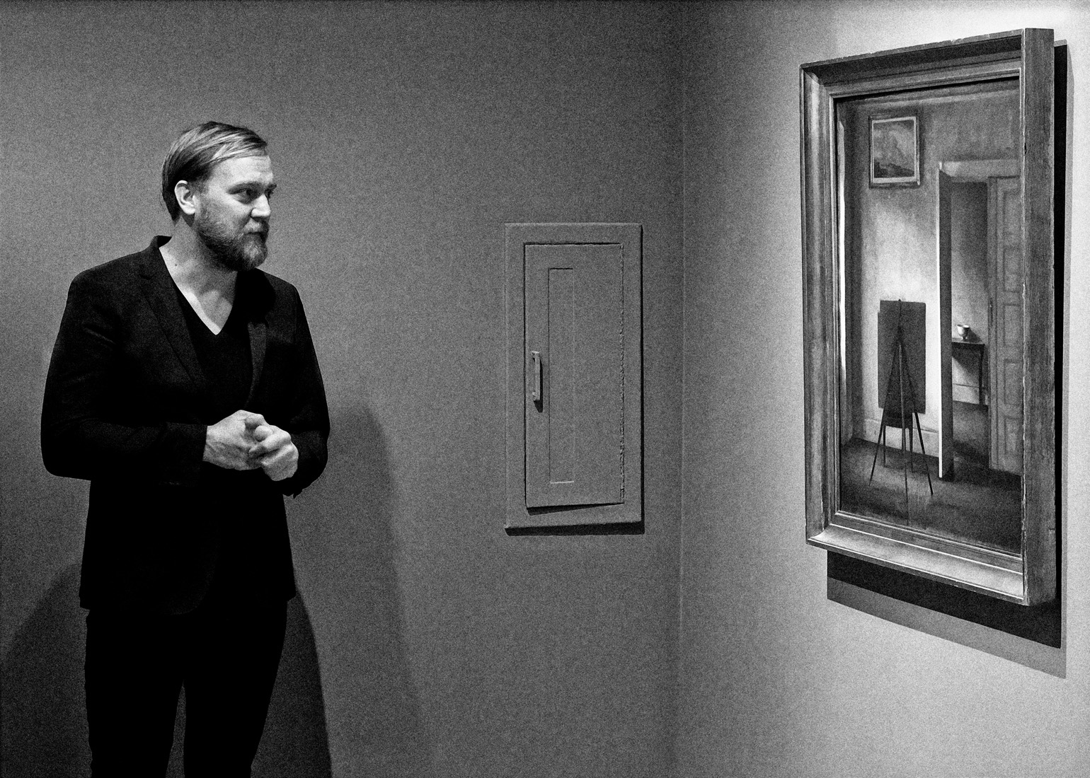 the artist looking at a painting in the museum