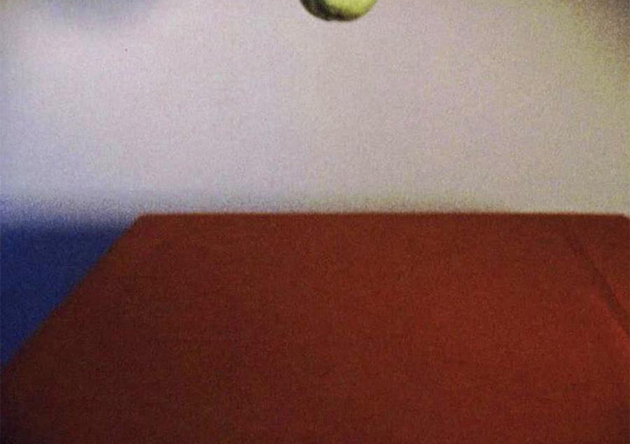 pear falling onto a red table